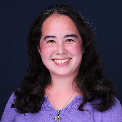 A smiling half-Chinese half white woman with long dark brown hair.